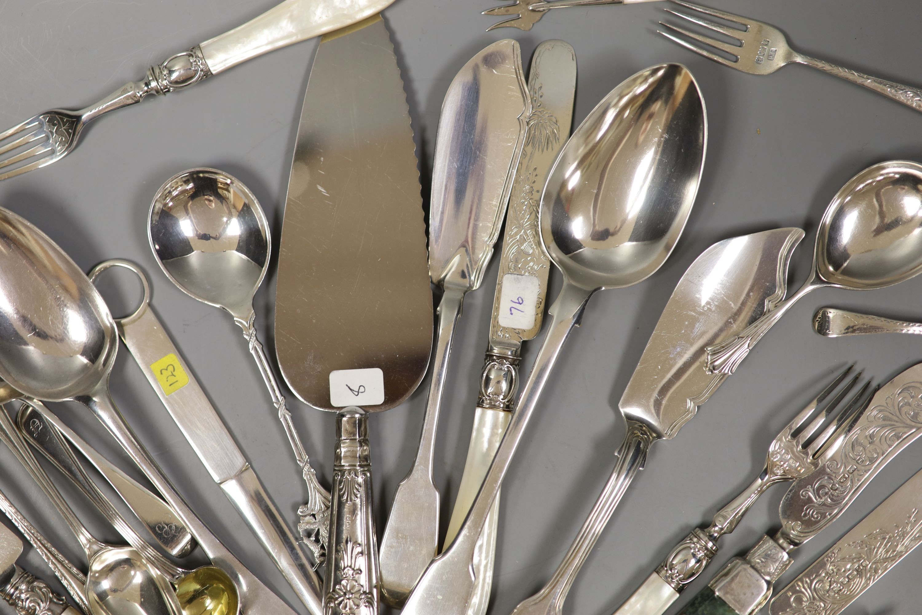 Four Victorian and later silver butter knives including Newcastle and a group of assorted silver flatware including two 19th century caddy spoons, tablespoons, letter opener and a Victorian agate handled butter knife.